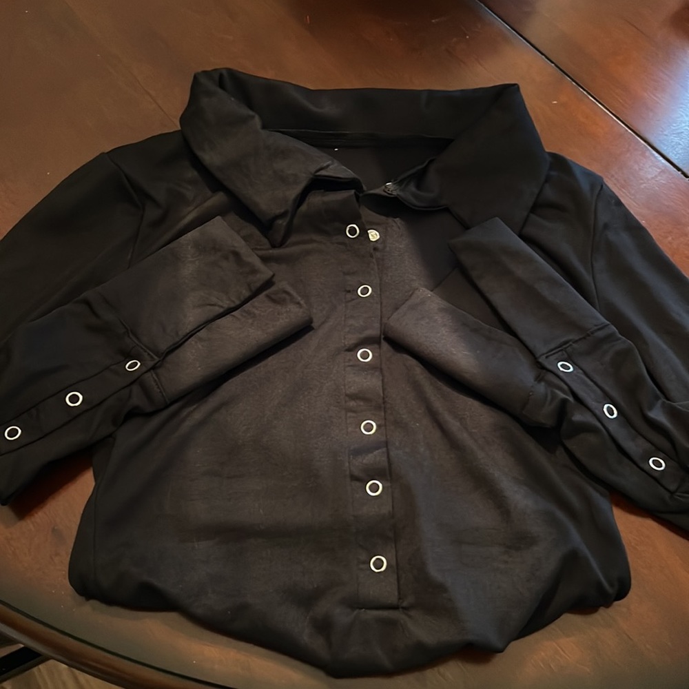 Sexy Black bodysuit with seven snap buttons in front. Long sleeve. Never worn.